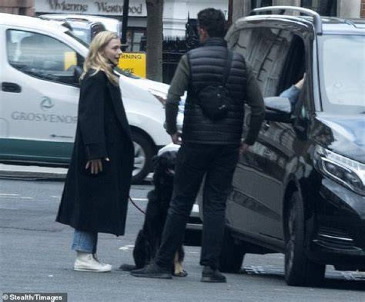 Practical:&nbsp;Her companion kept a low profile in a padded gilet and green jumper which he teamed with jeans